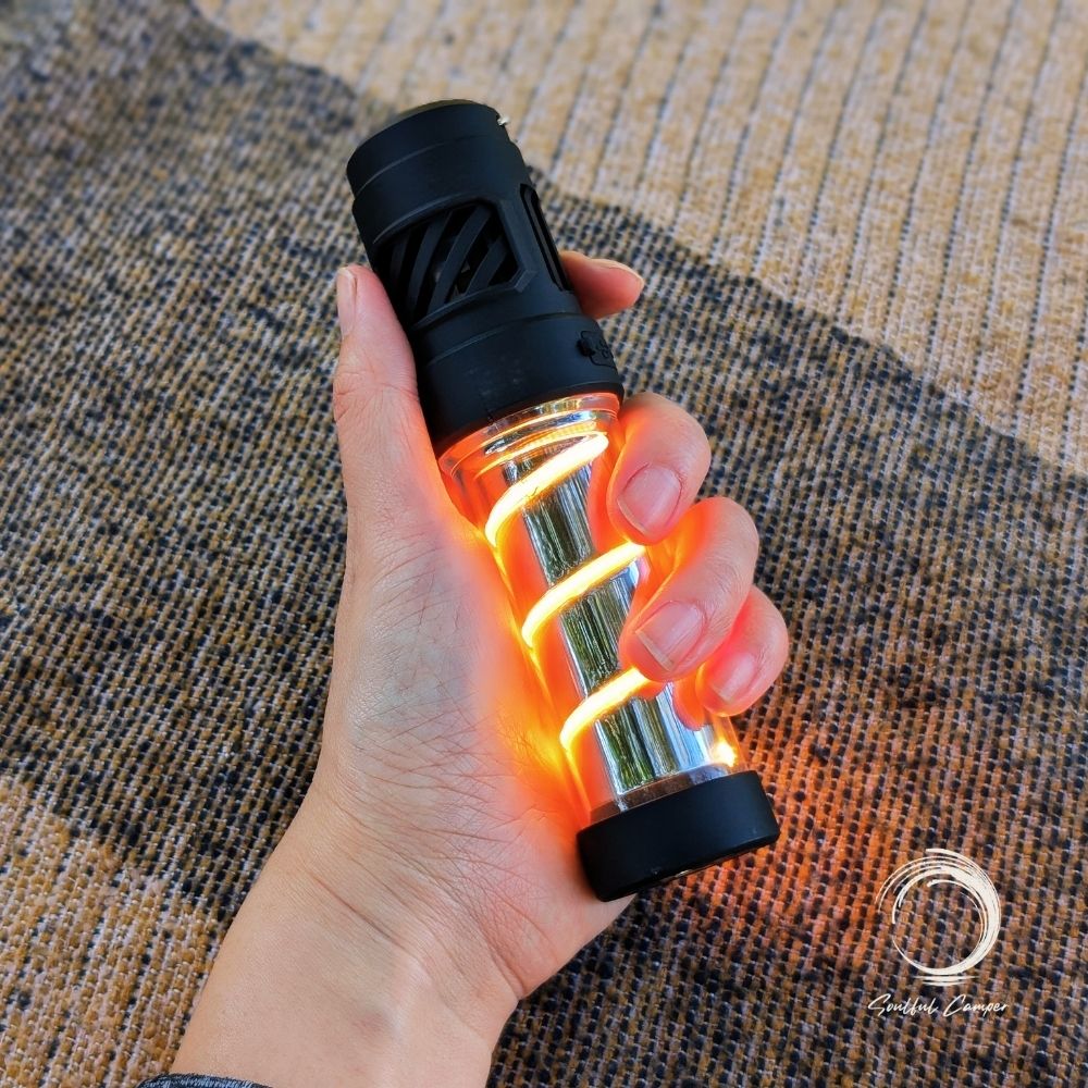 Hand holding illuminated Silent Lantern with warm glow