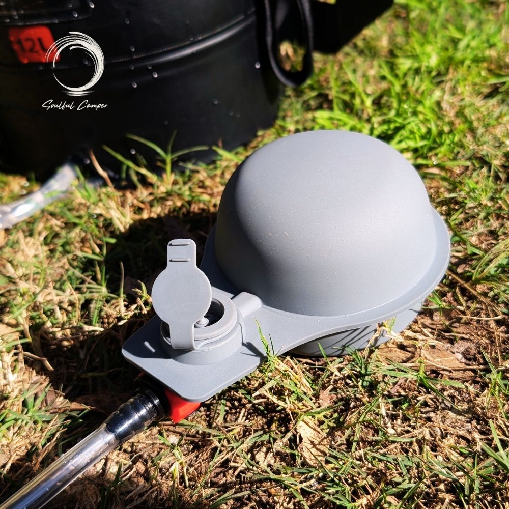 Close-up of grey foot pump for Soulful Camper Sun Shower on grass