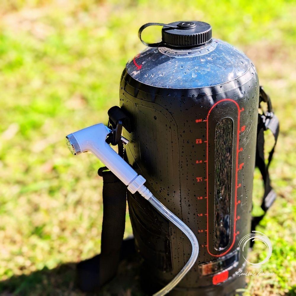 Sun Shower with hose nozzle attached and red volume scale on black bag