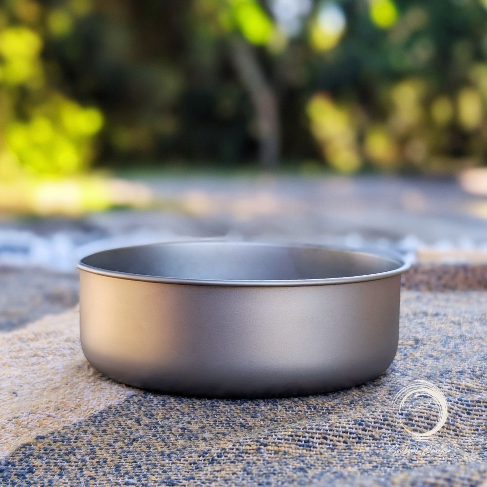 Side view of Soulful Camper Ti-Bowl on picnic blanket with blurred outdoor background