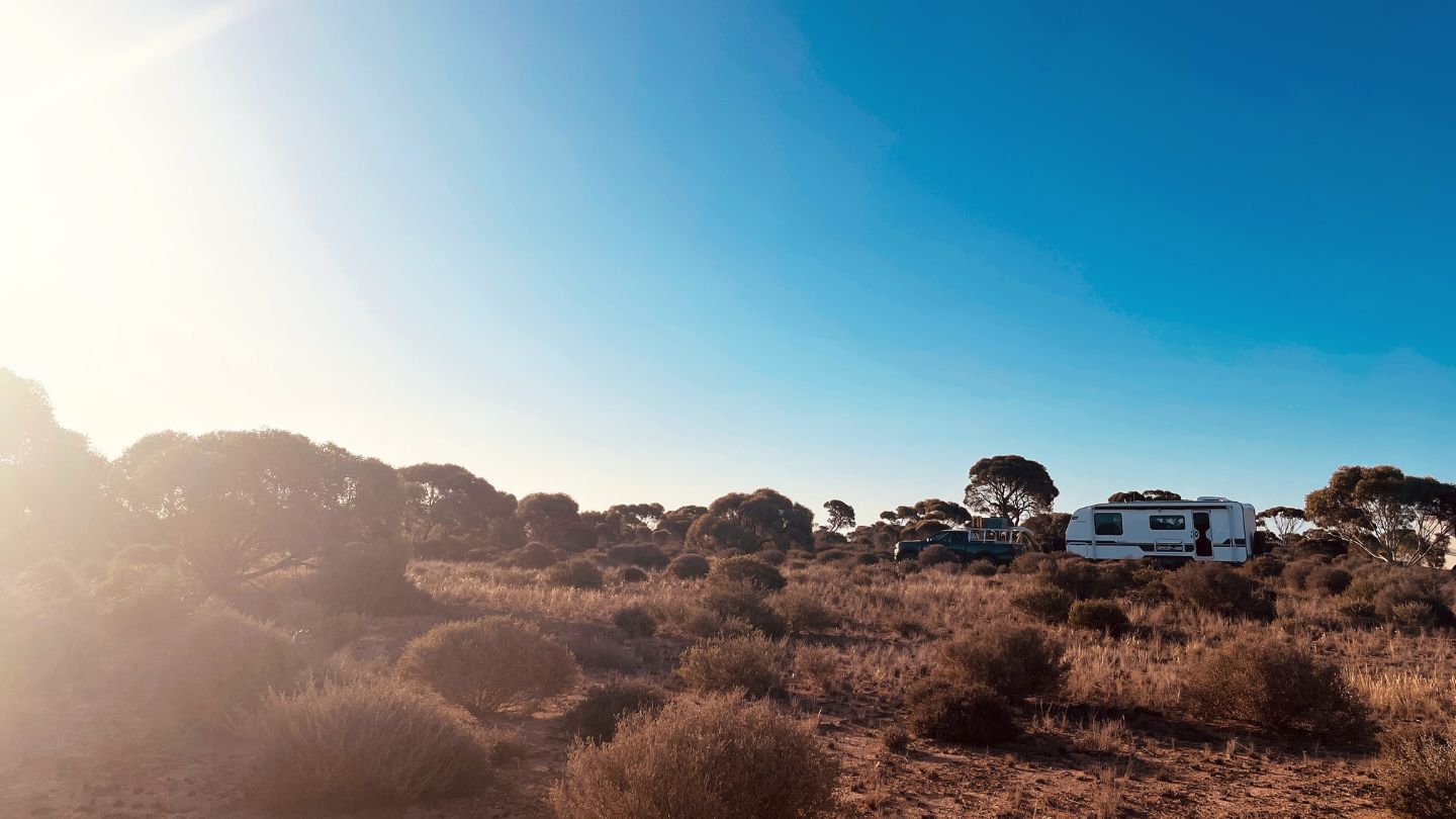 australian-outback-caravan-camping Caravan parked at a roadside camping spot on the Nullarbor Plain surrounded by Australian bushland.